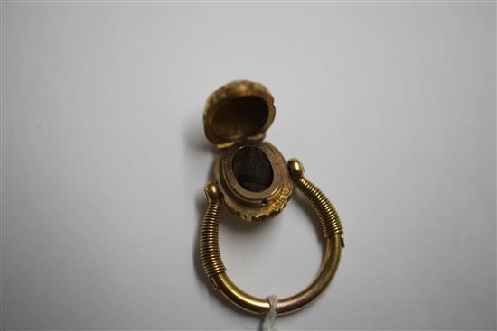 An early 20th century 14k gold swivelling Scarab locket ring, size N.